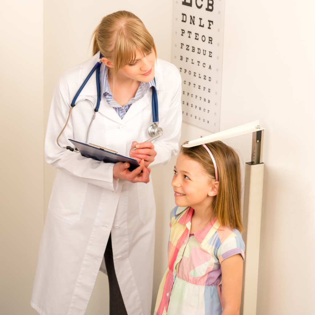 Healthcare professional measuring height of a child